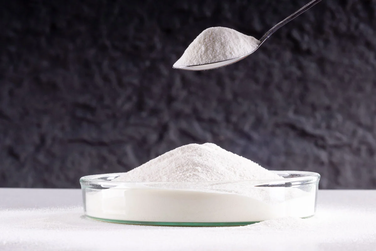a-petri-dish-containing-white-fish-collagen-peptide-powder-sits-on-the-table.webp