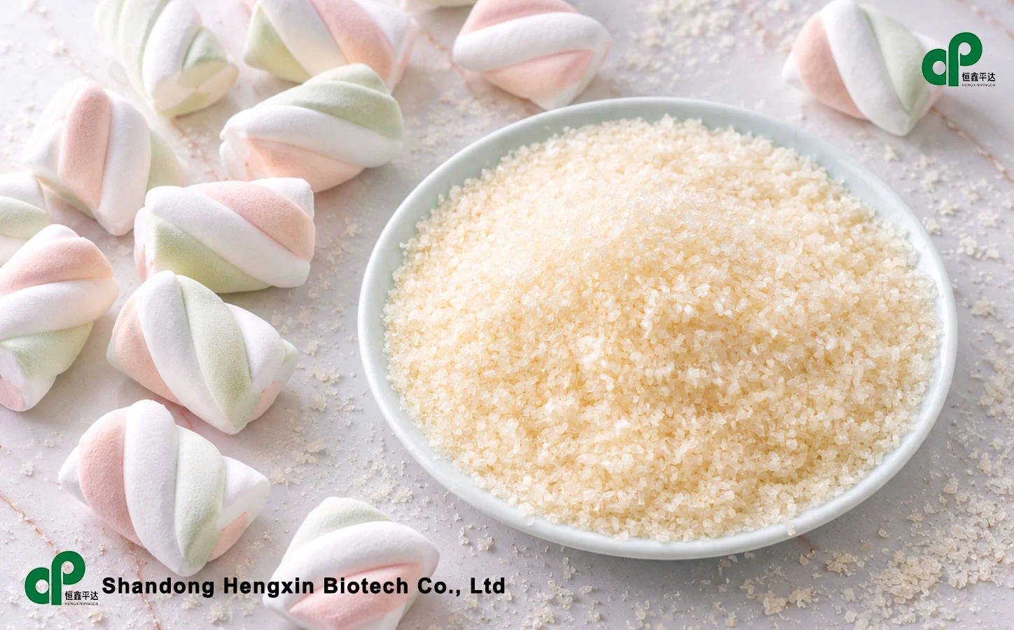 Gelatin powder in a porcelain bowl paired with two-tone marshmallows on a table